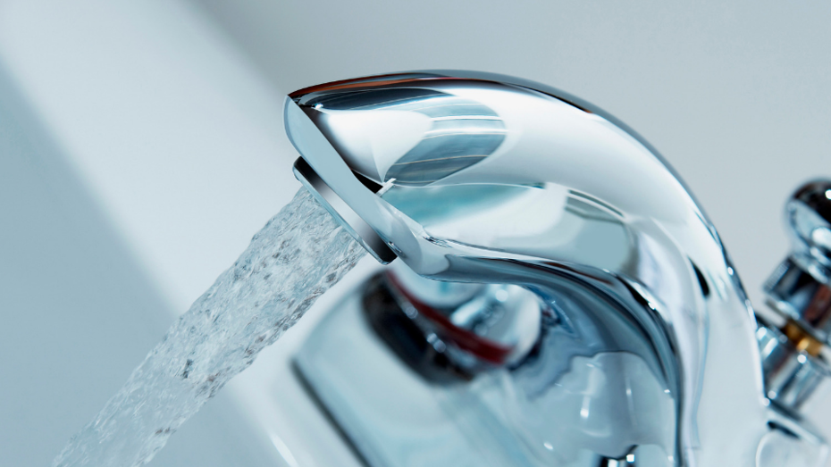 Water flowing from an open tap into a sink, possibly in a bathroom or kitchen. Water flowing from an open tap into a sink, possibly in a bathroom or kitchen.