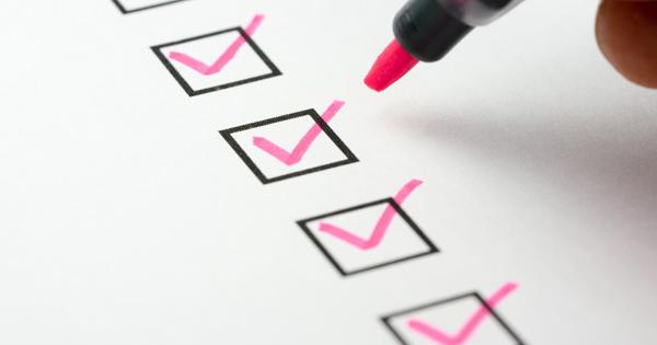 Hand holding a pink marker checking off items on a checklist, with three boxes already ticked.