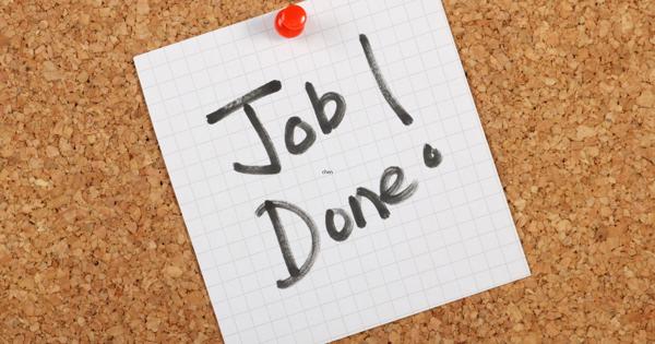 Graph paper pinned to a corkboard with a red pushpin, displaying the handwritten message 'Job! Done.' in black marker