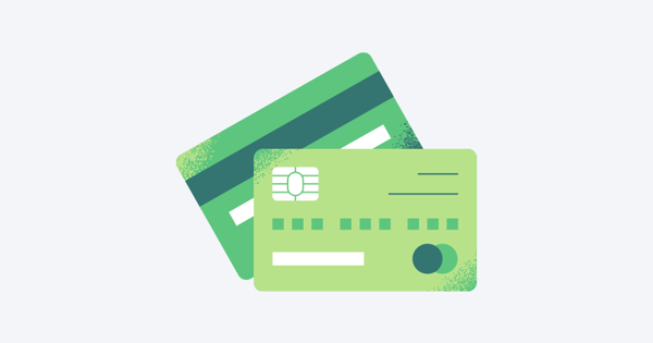 wo green credit cards, one in the foreground showing a chip, number placeholders, and a circular shape on the bottom right; the other in the background with a dark green stripe.