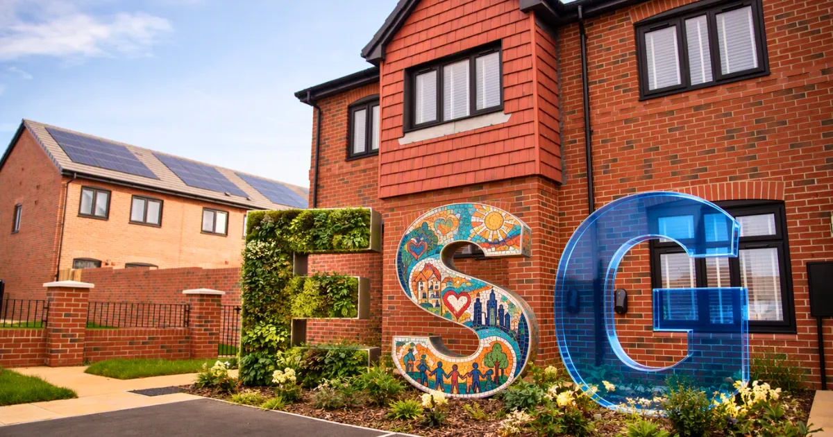 Decorative ESG letters outside modern homes, illustrating the link between sustainability, community and governance.