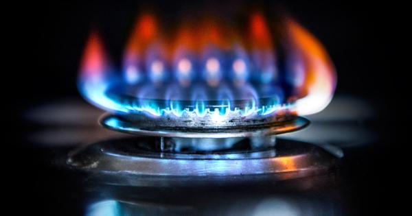 Blue flames burning on a gas stove burner.