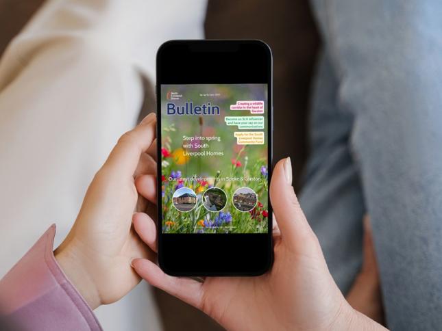 Smartphone displaying a South Liverpool Homes bulletin with spring-themed graphics, housing development updates, and community engagement opportunities, held in hand against a neutral background. Smartphone displaying a South Liverpool Homes bulletin with spring-themed graphics, housing development updates, and community engagement opportunities, held in hand against a neutral background.