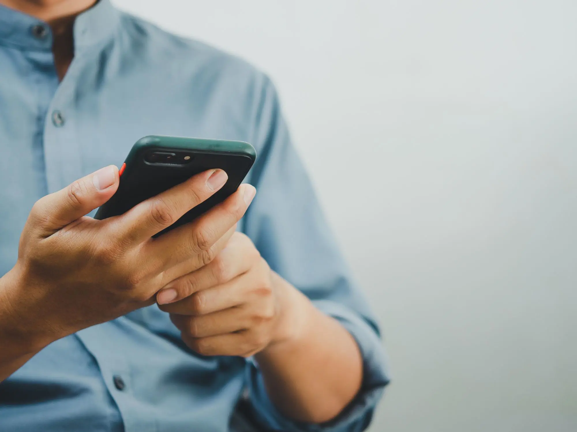 Person using a smartphone, representing how residents can report anti-social behaviour online quickly and easily.