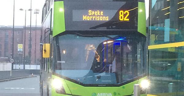 Green Arriva double-decker bus on route 82 to Speke Morrisons, registration BW66 GYT, parked in an urban area.