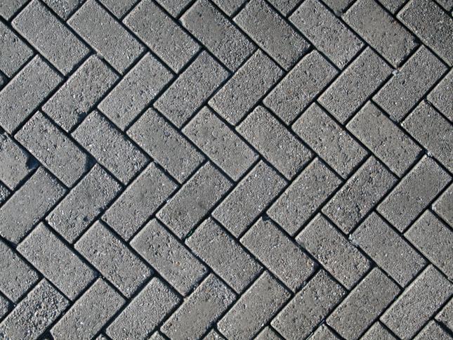 Interlocking brick pattern in a herringbone design with a large blurred rectangular area in the centre obscuring part of the bricks. Interlocking brick pattern in a herringbone design with a large blurred rectangular area in the centre obscuring part of the bricks.