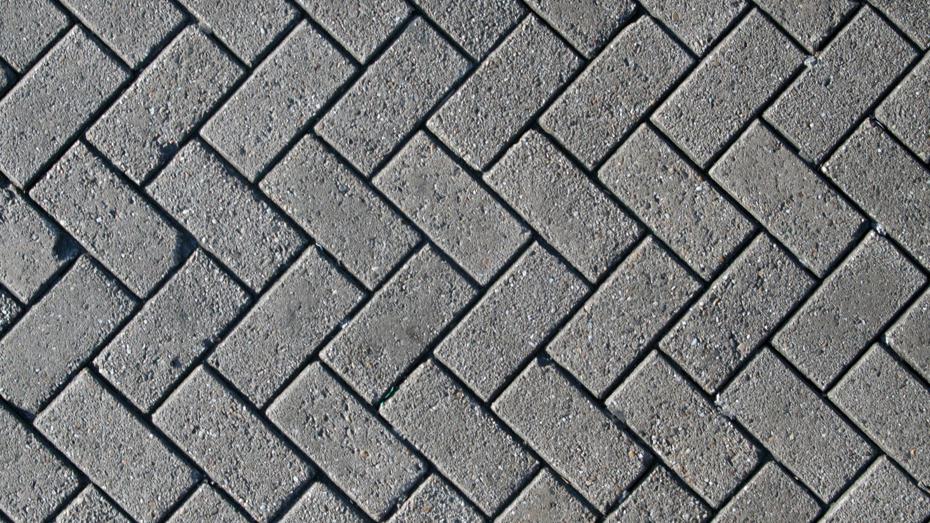 Interlocking brick pattern in a herringbone design with a large blurred rectangular area in the centre obscuring part of the bricks. Interlocking brick pattern in a herringbone design with a large blurred rectangular area in the centre obscuring part of the bricks.
