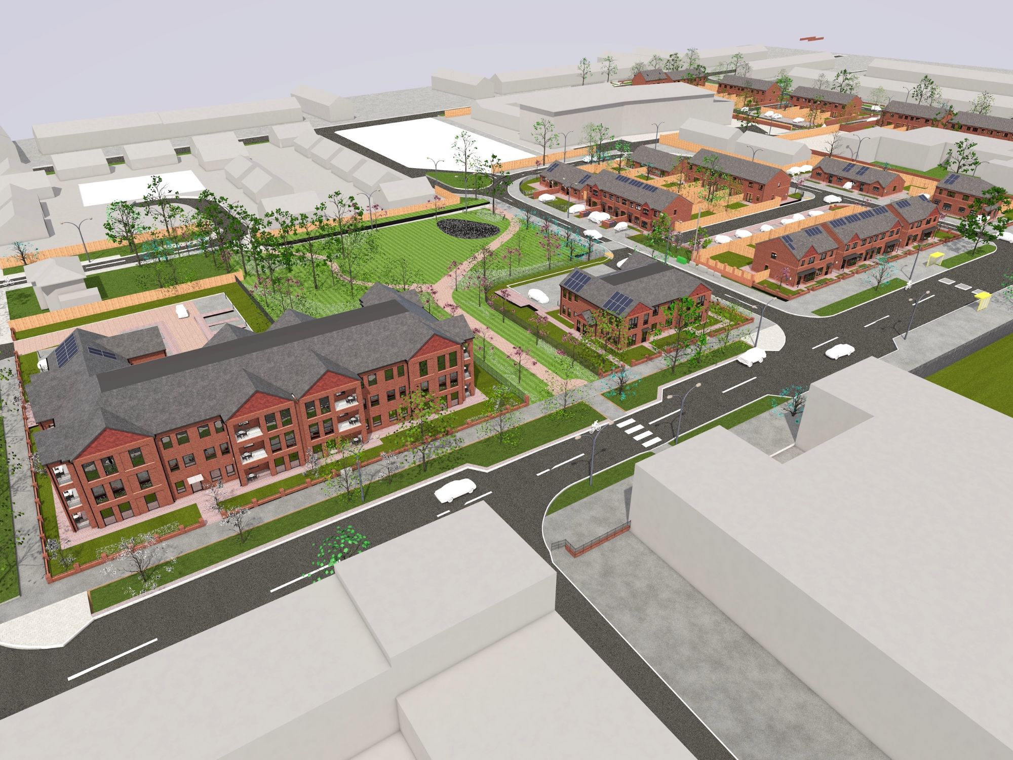 Aerial view of a planned residential development featuring red brick multi-story buildings, smaller homes with solar panels, organized streets, crosswalks, sidewalks, and landscaped green spaces with trees and grass.