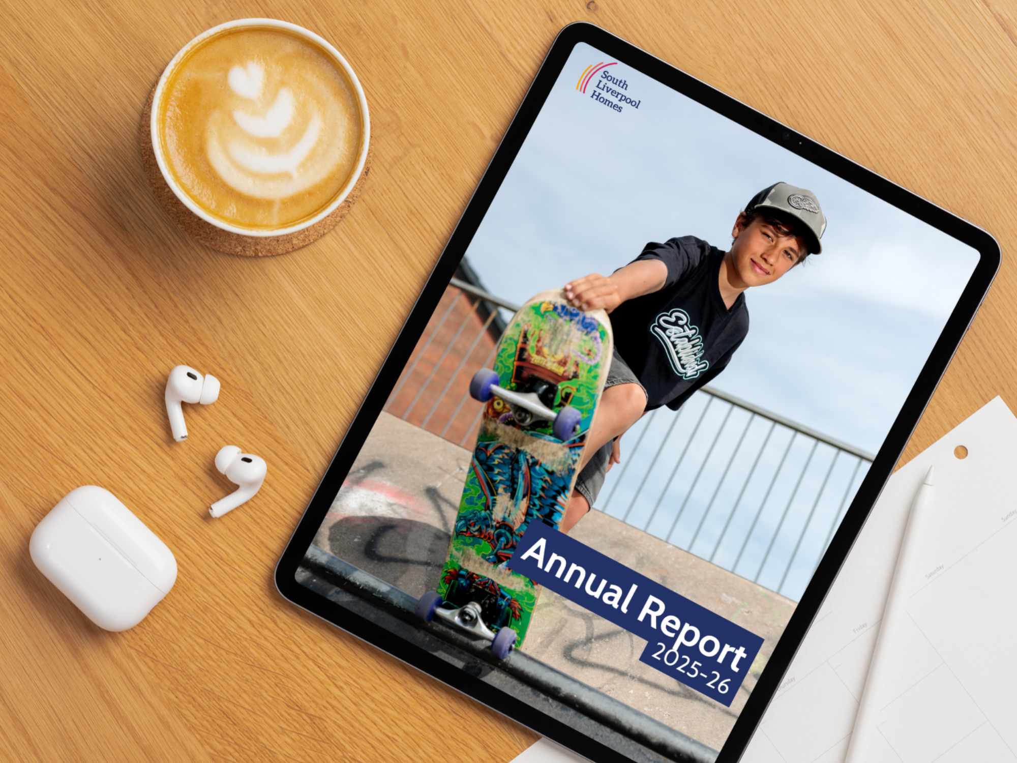 South Liverpool Homes Annual Report 2025/26 displayed on a tablet screen on a desk.