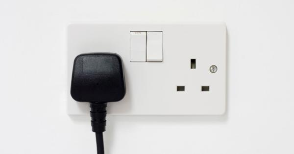 UK electrical outlet with a plug inserted and switches visible.