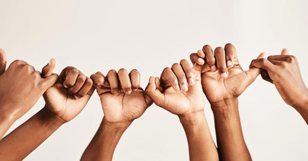 Group of hands linking pinkie fingers in unity, symbolising trust, connection, and access to community safety resources and support.