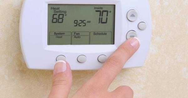 Close-up of a digital thermostat showing "Heat Setting 68°," "Inside 70°," and the time 9:25 AM, with options for System Heat, Fan Auto, and Schedule.