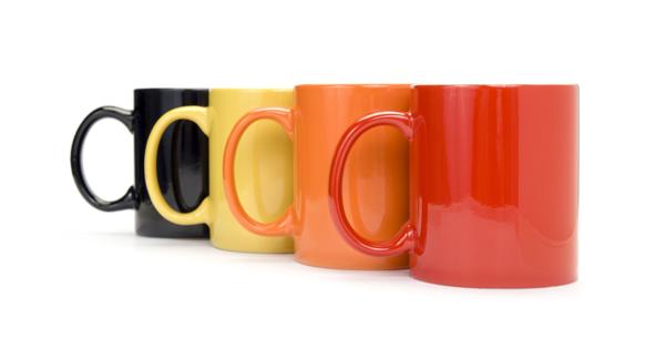Four colourful mugs lined up in a row, symbolising informal, welcoming community safety drop-in sessions where residents can speak to staff over a cuppa.