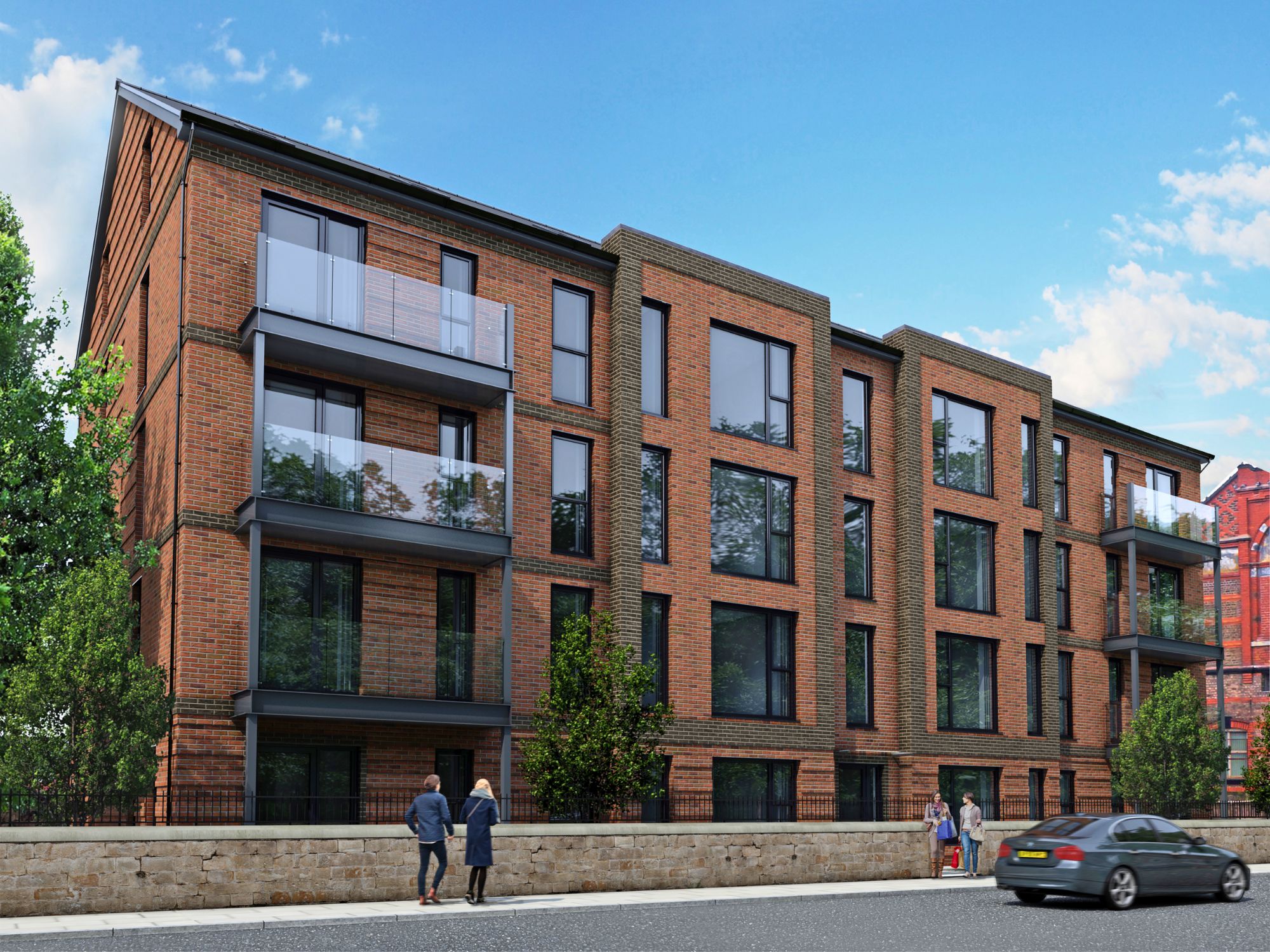 Modern multi-story brick apartment building with large windows and glass balconies, surrounded by greenery and a stone wall, with pedestrians and a car on the nearby road.