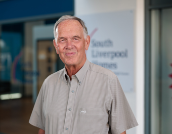 Portrait image of Clive Elliott, Chair of the Board, outside South Liverpool Homes' offices 