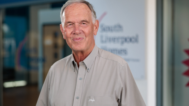 Portrait image of Clive Elliott, Chair of the Board, outside South Liverpool Homes' offices 